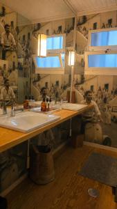 a bathroom with a sink and two men working at Ferreirinha Valley in Vieira do Minho +17 photos