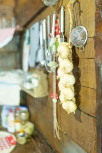 a bunch of garlic hanging on a wall at Brvnara Jez in Kraljevo