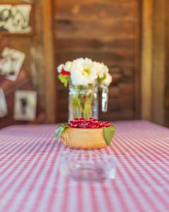 a vase of flowers sitting on a table with a vase at Brvnara Jez in Kraljevo