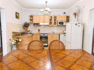 a kitchen with a table and a refrigerator at Astronomical Clock Apartment in Prague