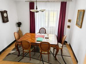 a dining room with a wooden table and chairs at Astronomical Clock Apartment in Prague +5 photos