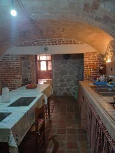 a kitchen with two tables and a sink at Il Rustico in Celano