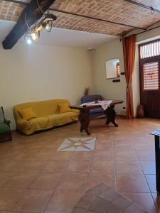 a living room with a couch and a table at Il Rustico in Celano