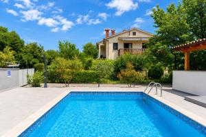 a swimming pool in front of a house at Magnolia by Briskva in Vinež