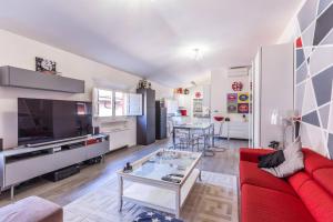 a living room with a red couch and a table at De' Fusari, Bologna by Short Holidays in Bologna