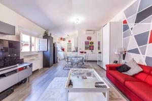 a living room with a red couch and a table at De' Fusari, Bologna by Short Holidays in Bologna