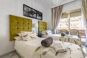 a bedroom with two beds and a window at Doña Sofía in Fuengirola