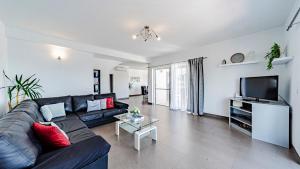 a living room with a black couch and a tv at Villa Antonia by Villas Guide in Blato