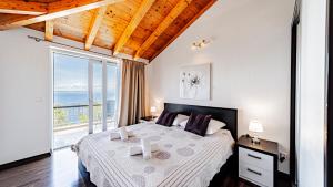 a bedroom with a large bed and a large window at Villa Antonia by Villas Guide in Blato +38 photos
