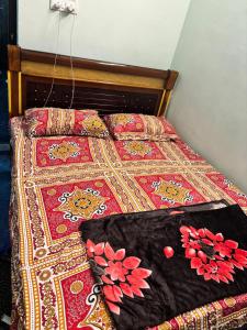 a bed with a colorful blanket and pillows on it at Lara Homestay 1bhk Begumpet in Hyderabad