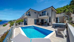 a villa with a swimming pool and a house at Villa Antonia by Villas Guide in Blato