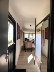 a hallway of a caravan with a door and a table at A View for Two in Tarchamps +14 photos