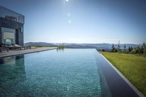 a swimming pool in front of a house at Hochblauen Hotel in Badenweiler