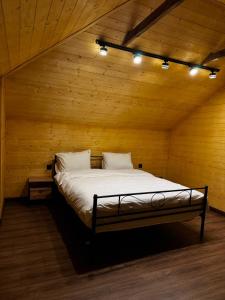 a bedroom with a bed in a wooden room at Sargsyans house in Dilijan +20 photos