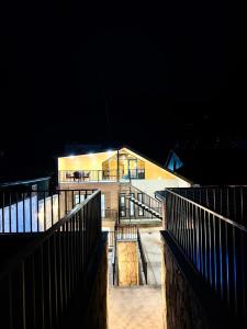 a large building at night with lights on at Sargsyans house in Dilijan
