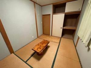 an empty room with a wooden table in the floor at あざみ庵 屋久島 in Yakushima