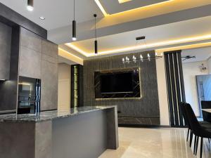 a kitchen with a bar and a tv on the wall at Sargsyans house in Dilijan