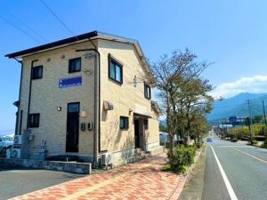 a small building on the side of a street at あざみ庵 屋久島 in Yakushima