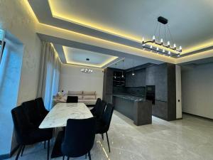 a kitchen and dining room with a table and chairs at Sargsyans house in Dilijan