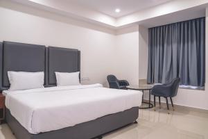 a bedroom with a bed and a table and chairs at Chhapaak Resort in Patna