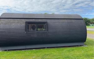 a black trailer with a window in a field at Gorgeous Home In Skjern in Skjern