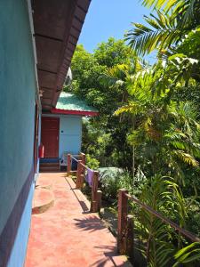 a walkway outside of a house with trees at D view hill hotel in Kuala Tahan