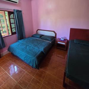 a bedroom with a bed and a side table at D view hill hotel in Kuala Tahan