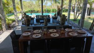 a table and chairs with a table and a couch at Life is One in Uluwatu