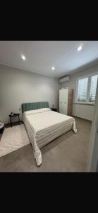 a bedroom with a large bed in a room at THE PORT Guest Rooms in San Ferdinando