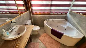 a bathroom with a tub and a sink and a toilet at Infinity villa in Fethiye +11 photos
