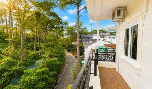 a balcony with a view of a river and trees at Lien's 2 Hotel Dalat in Da Lat