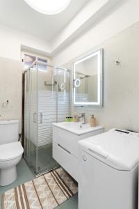 a bathroom with a toilet and a sink and a shower at Minimal Stay House in Petalidi +3 photos