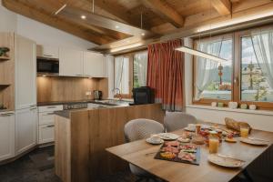 a kitchen with a wooden table with food on it at Lehner Schlössl in Leutasch