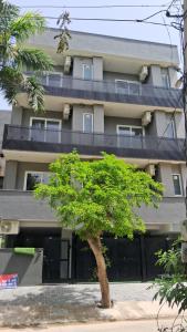 a building with a tree in front of it at Hotel Venezia Grand in Gurgaon
