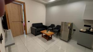 a waiting room with chairs and a table and a door at Hotel Venezia Grand in Gurgaon