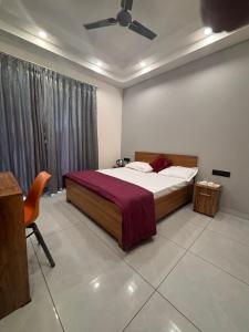 a bedroom with a bed and a ceiling fan at Hotel Venezia Grand in Gurgaon