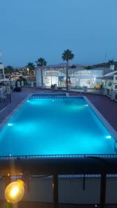 a large blue swimming pool on top of a building at Comfortable apartment with balcony and huge pool in Sucina