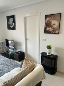 a living room with a couch and a table at Comfortable apartment with balcony and huge pool in Sucina