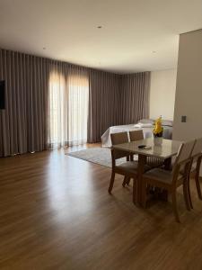 a bedroom with a bed and a table and chairs at Studio Liv in Sorriso