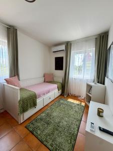 a small bedroom with a bed and a desk at Holiday Village 8C in Senec