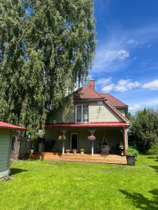 a house with a porch and a yard at Vase Holiday Home in Tartu