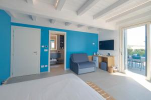 a blue room with a bed and a chair at Villa Sarmassa in Narzole +76 photos