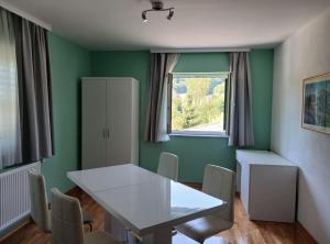 a dining room with a white table and chairs at Villa Lika in Plitvička Jezera