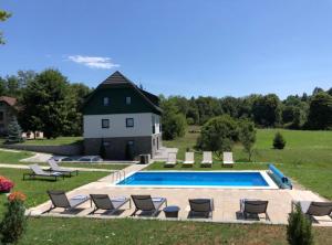 a swimming pool in front of a house at Villa Lika in Plitvička Jezera