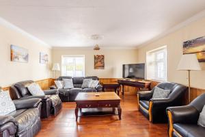 a living room with leather couches and a table at Explore the west in Loughrea