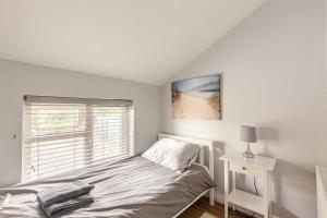 a white bedroom with a bed and a window at Explore the west in Loughrea