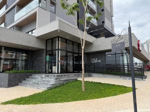 a building with a tree in front of it at Studio Liv in Sorriso