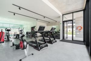 a gym with treadmills and elliptical machines at Seaside Beach Condo by Minho's Guest in Apúlia