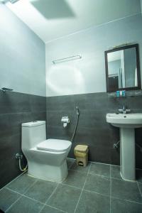 a bathroom with a toilet and a sink at Himalaya Forest Resort in Deorāli +21 photos