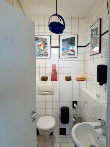 a bathroom with a toilet and a sink at Apartment Luk - Design trifft Zuhause in Furth im Wald +14 photos